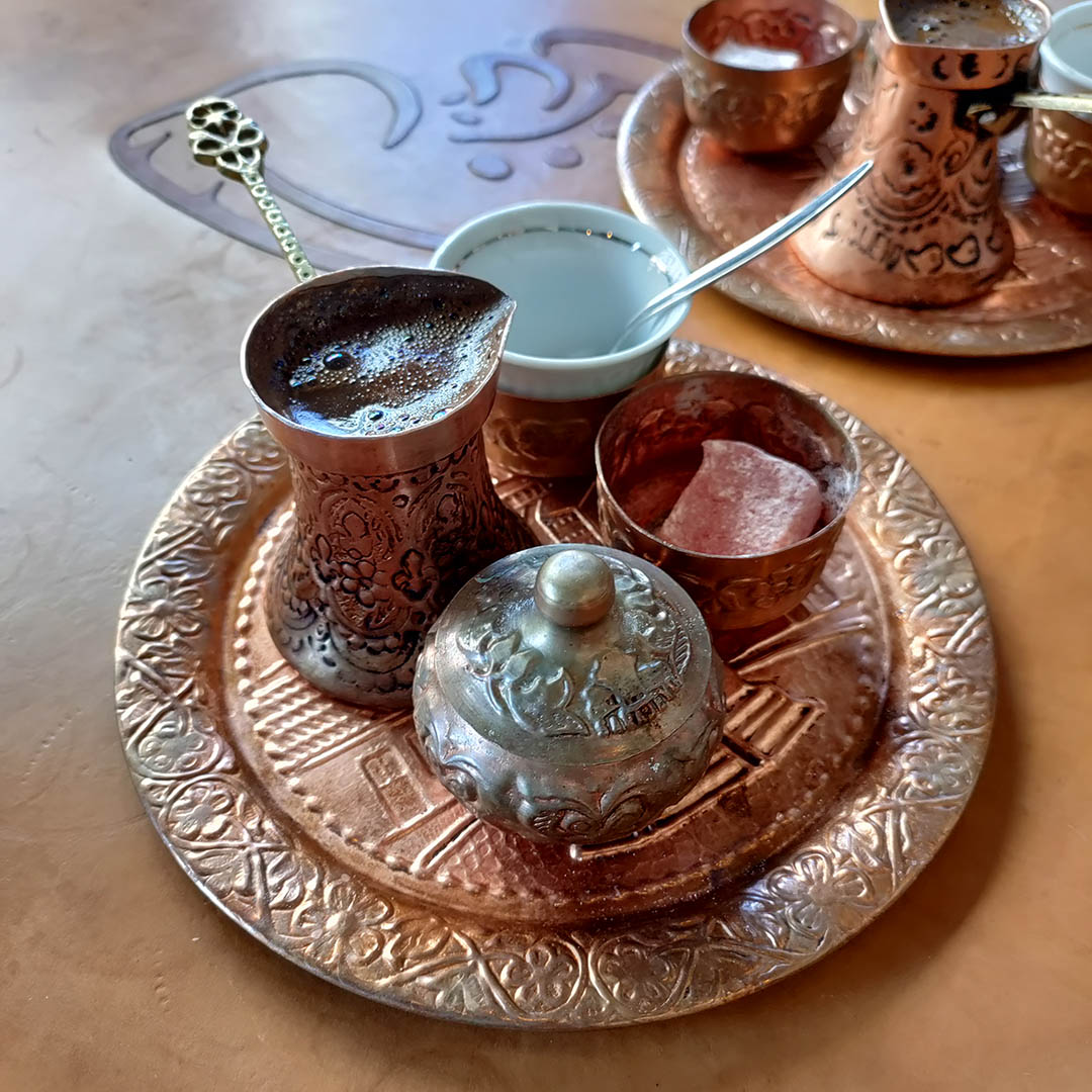 Bosnian coffee served with a Turkish delight in a small café in Sarajevo’s pedestrian area, run by young people. The coffee, bitter and dense, is made by letting the coffee grounds settle in hot water and is accompanied by a sugar cube or a sweet treat.